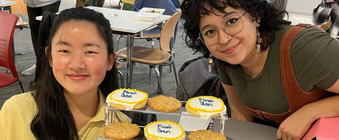 Two students with a bunch of cookies that say First Gen in frosting