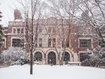 Exterior view of Leighton Hall during the winter with snow falling