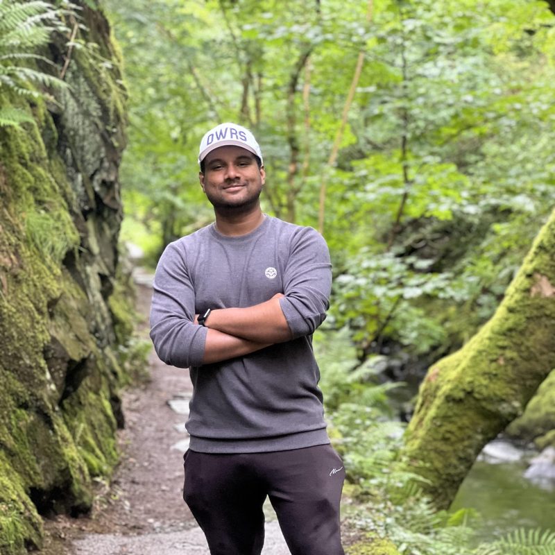 abrar standing along a forested trail