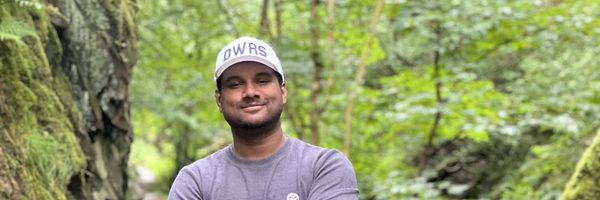 abrar standing along a forested trail