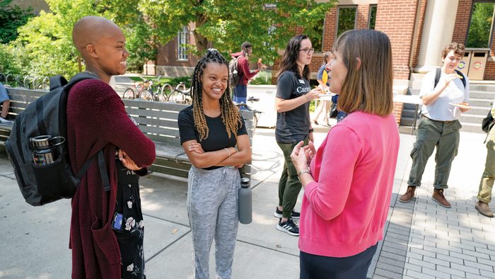 President Byerly talking with students outside Sayles-Hill student center