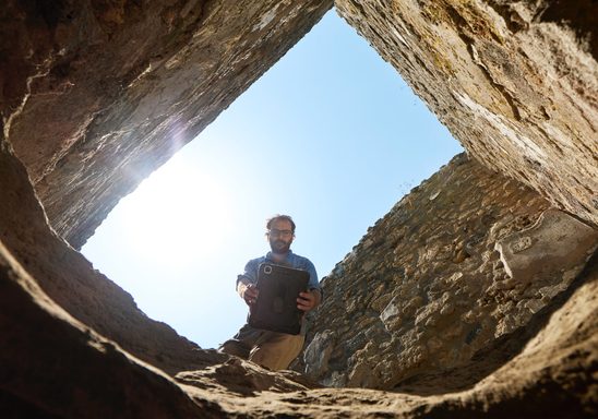 Dr. Jordan Rogers uses ipad Pro to conduct a 3D scan of the pit his team is excavating