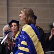 Alison smiling towards the crowd as she receives applause after her installation.