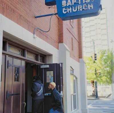 student walk through the door of a church