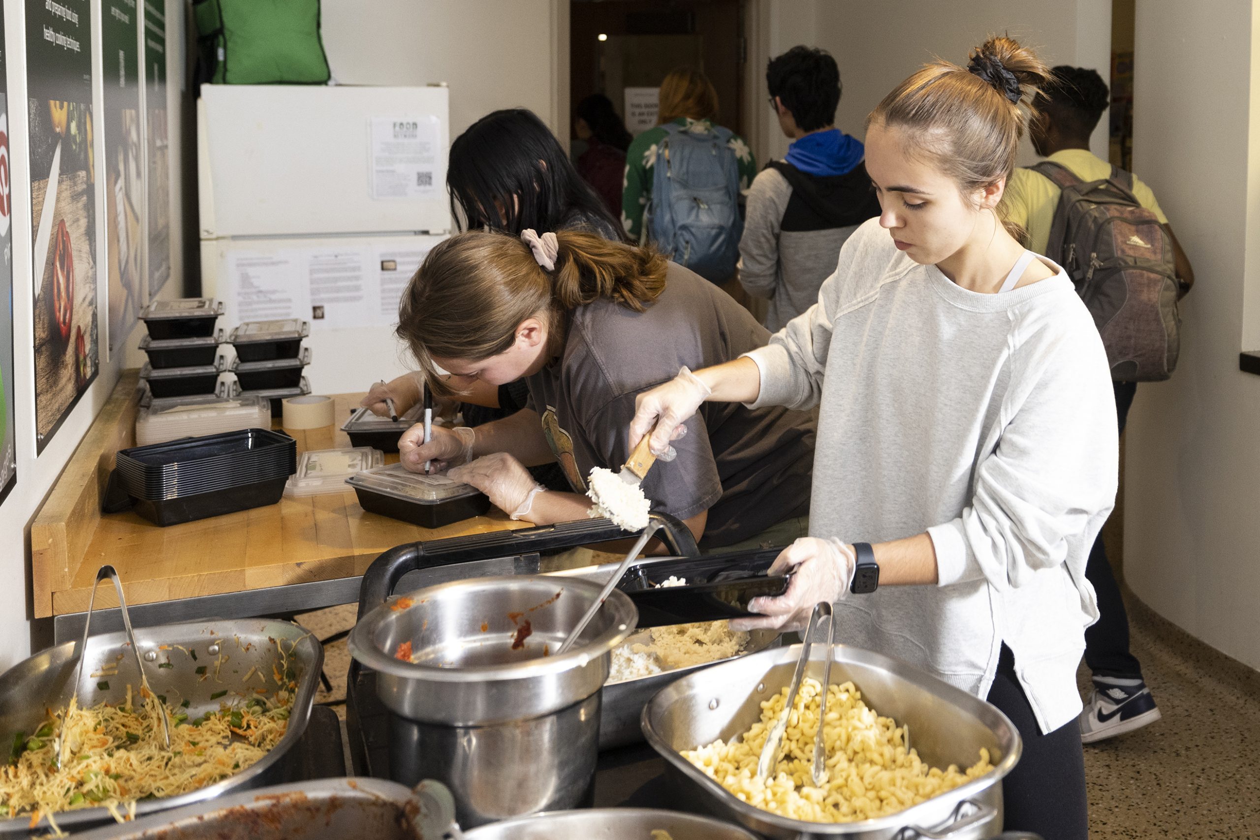 Student packaging up food as part of a Food Recovery Network effort
