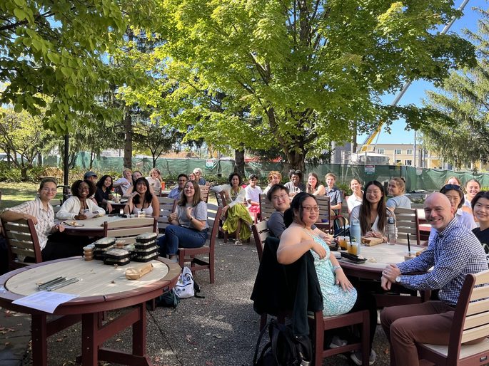 SOAN students and faculty posing for a group photo on the AGH patio at the fall '24 Welcome Back Lunch.