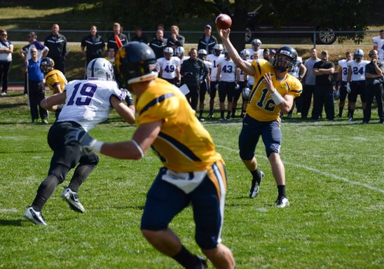 varsity football player prepares to recieve a catch