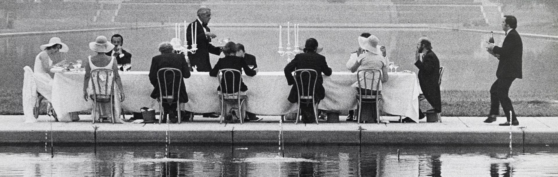 Black & white photo of a group of well-dressed people eating a fancy breakfast on the National Mall in Washington DC in 1975