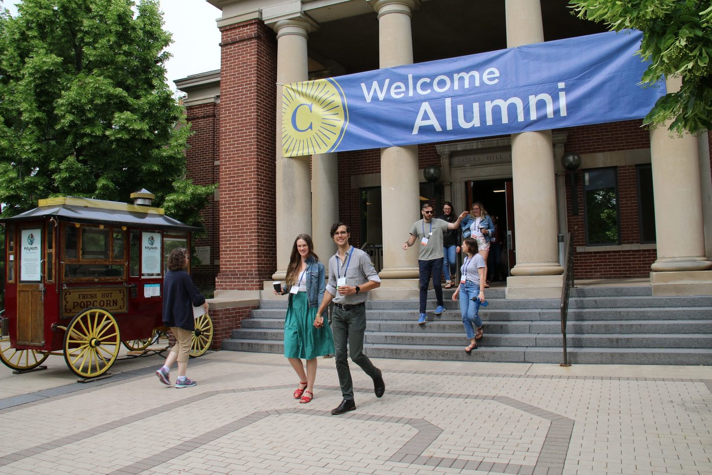 people under a banner that reads 