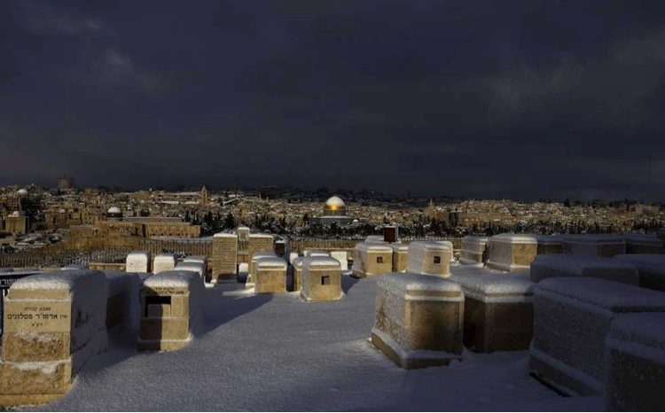 A snowy graveyard on a Jerusalem hilltop