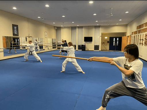 Aikido club/class wooden sword practice.